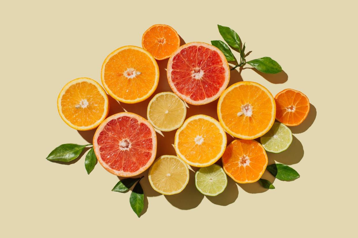 illustration of citrus fruit slices of lemons, oranges, grapefruit, lime on beige background healthy food, diet and detox concept flat top view