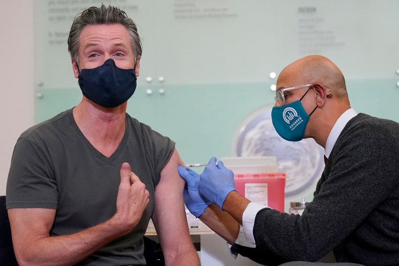 Gov. Gavin Newsom, left, received a shot of the Moderna COVID-19 vaccine from California Health and Human Services Secretary Dr. Mark Ghaly at Asia Health Services in Oakland on Oct. 27. 2021. Photo by Jeff Chiu, AP Photo