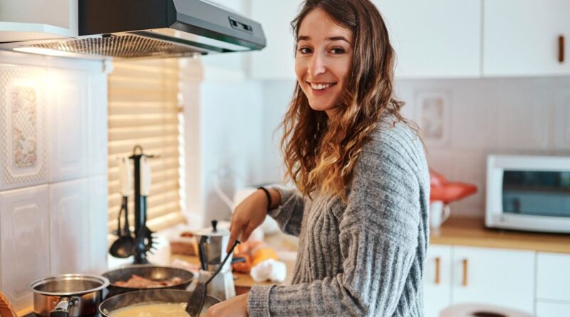 A woman cooks food.