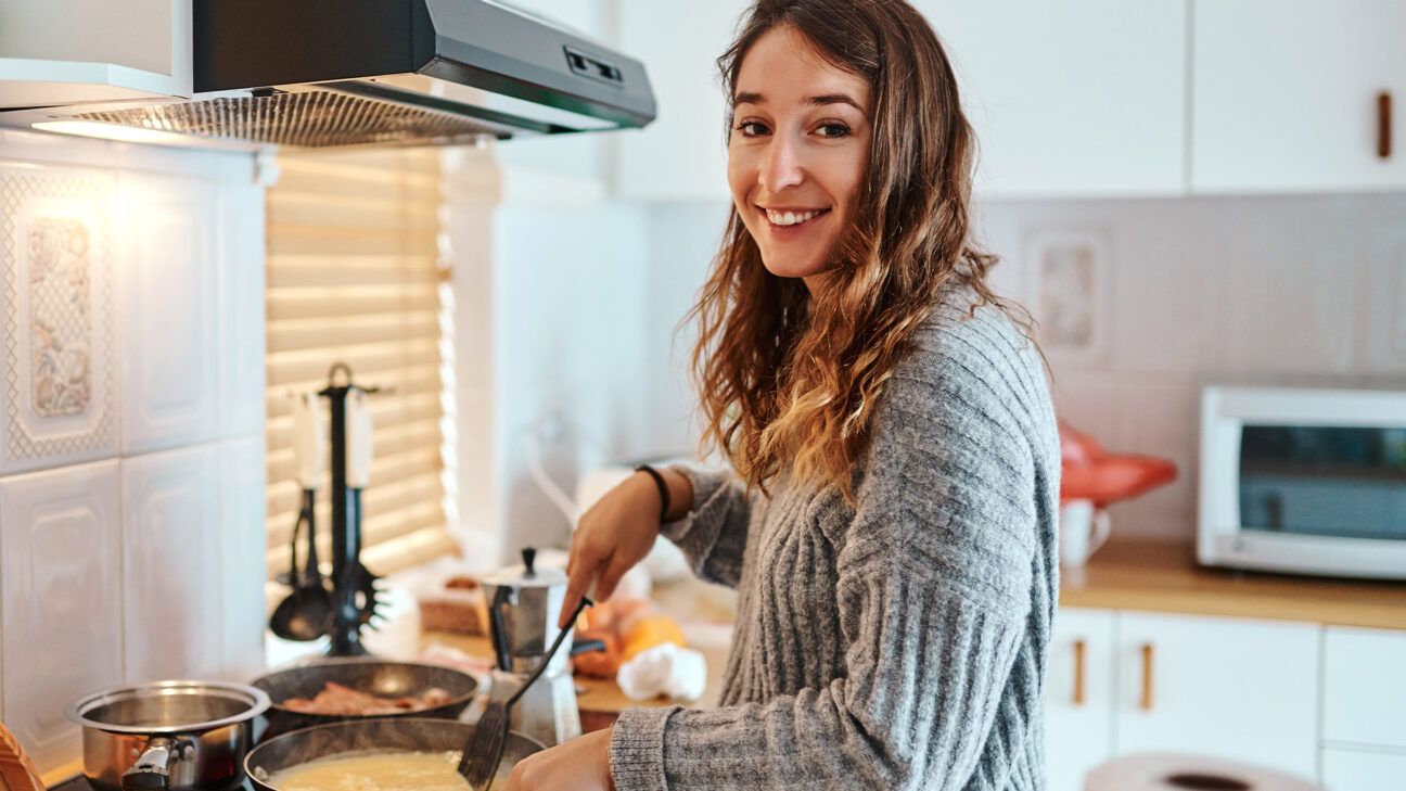 A woman cooks food.