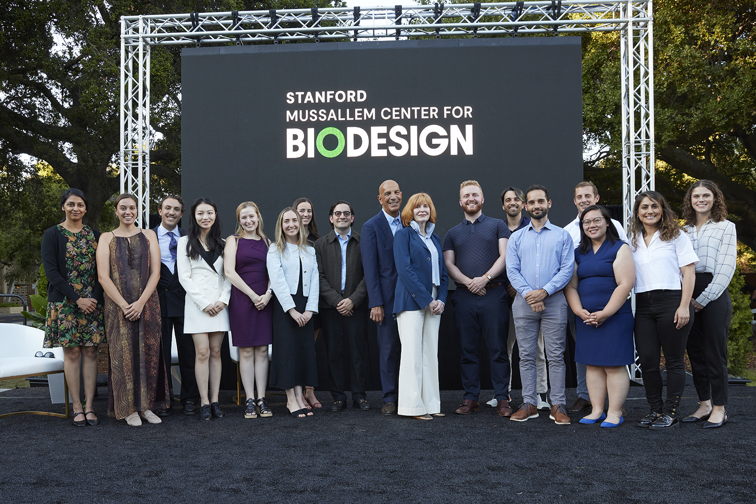 Pictured are Linda and Mike Mussallem on stage with the 2024-25 Stanford Biodesign Innovation and Policy Fellows.